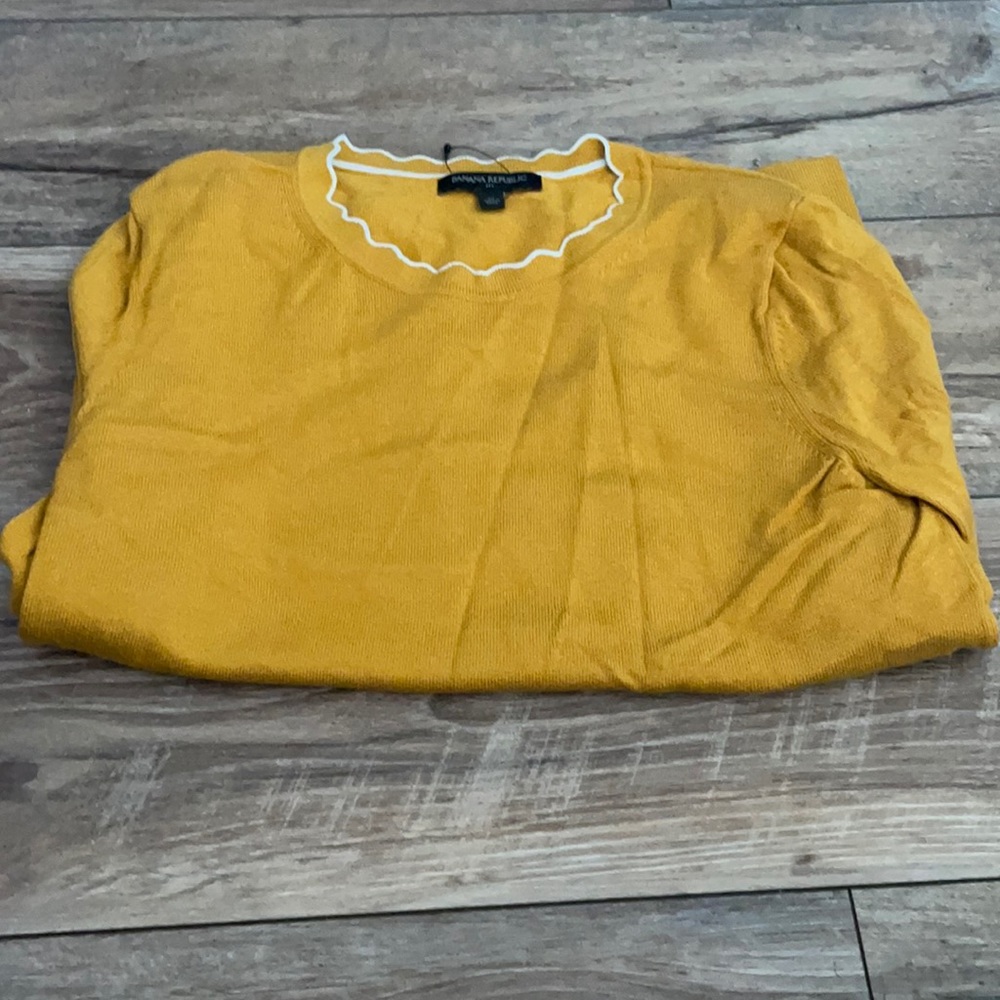 This is a yellow long sleeve shirt never worn. Size medium